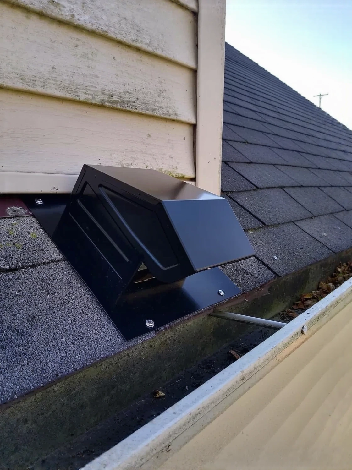 Customer photo showing mold growth and moisture damage in attic from improperly vented bathroom exhaust fan
