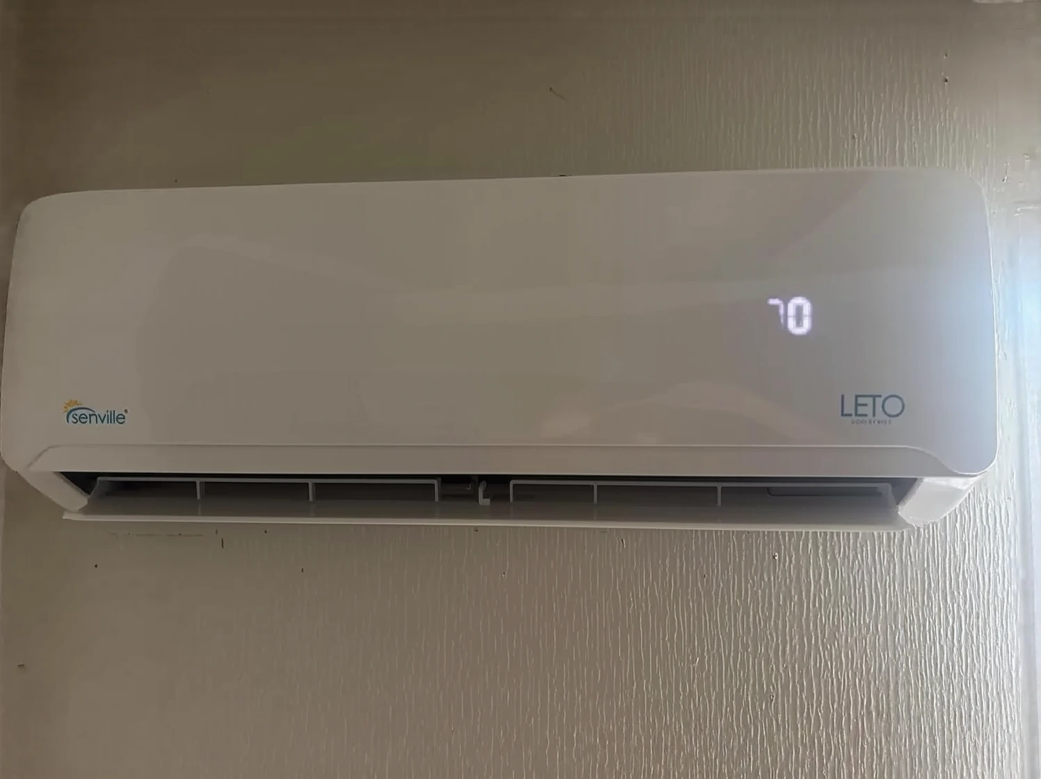 Customer photo of heat pump outdoor unit installed in snowy winter conditions