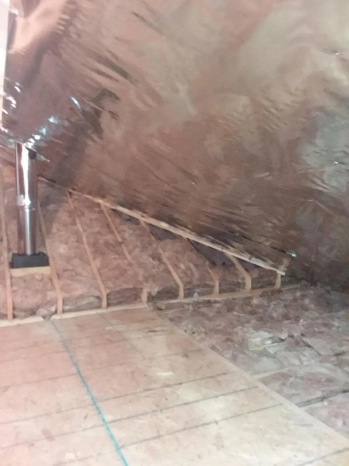 Customer photo of radiant barrier material installed in attic space showing reflective surface