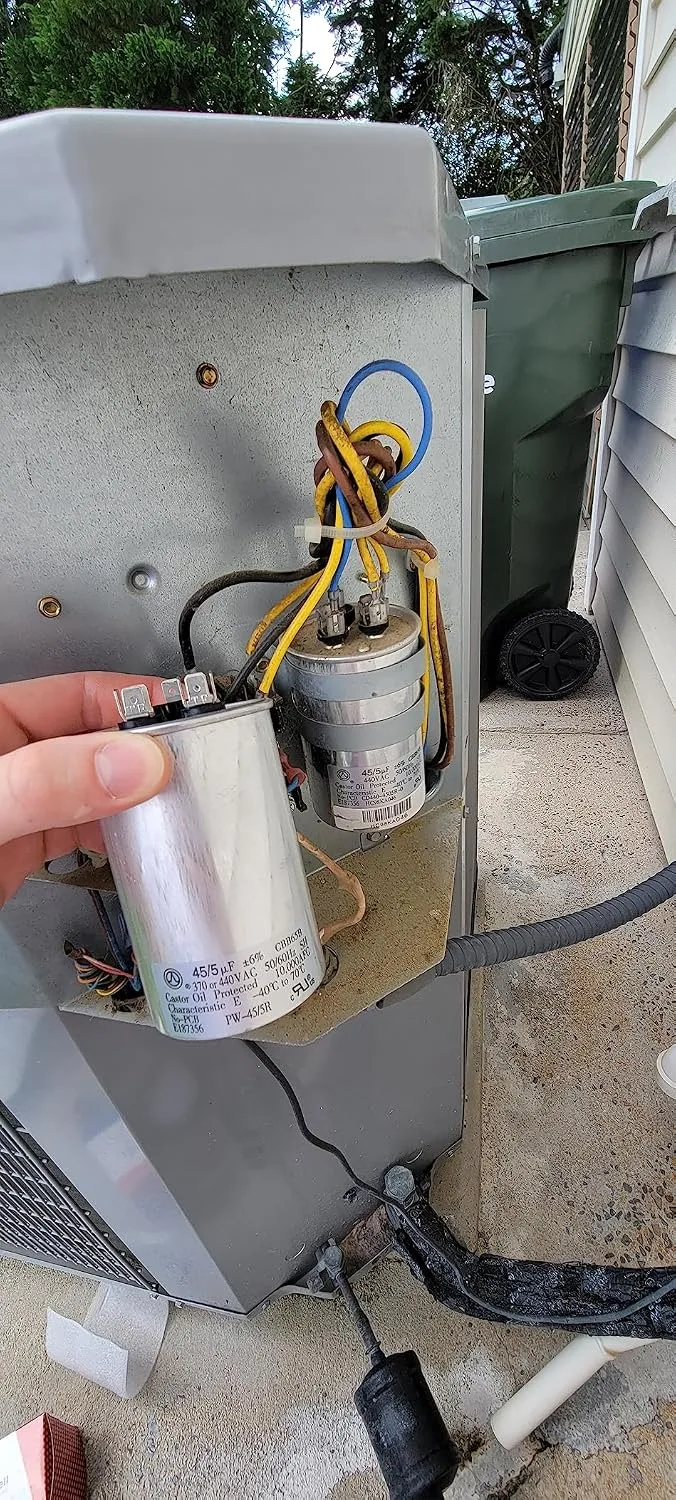 Customer photo of replacement AC capacitor next to original failed unit