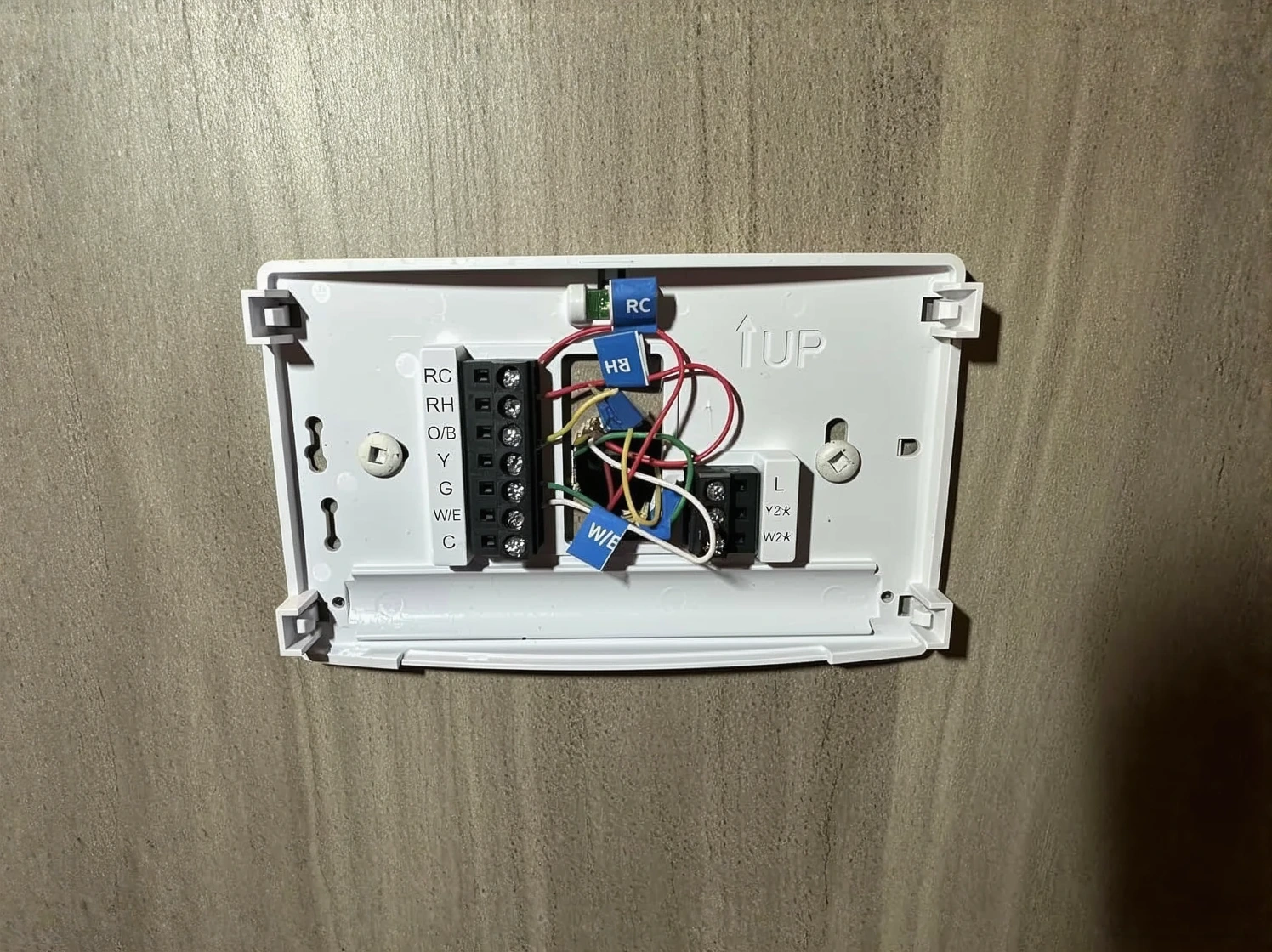 Customer photo of smart thermostat C-wire connection terminals on wall HVAC system