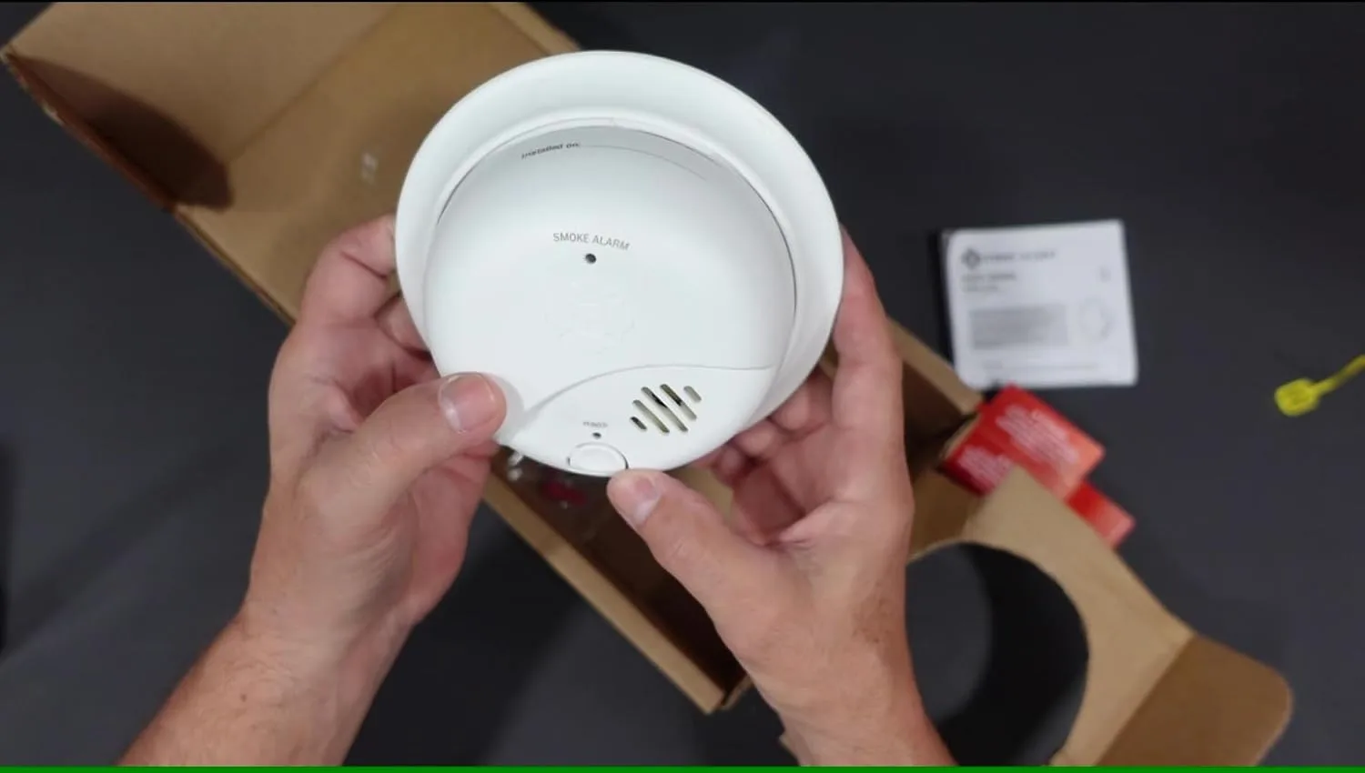 Customer photo showing smoke detector installation on ceiling near bedroom