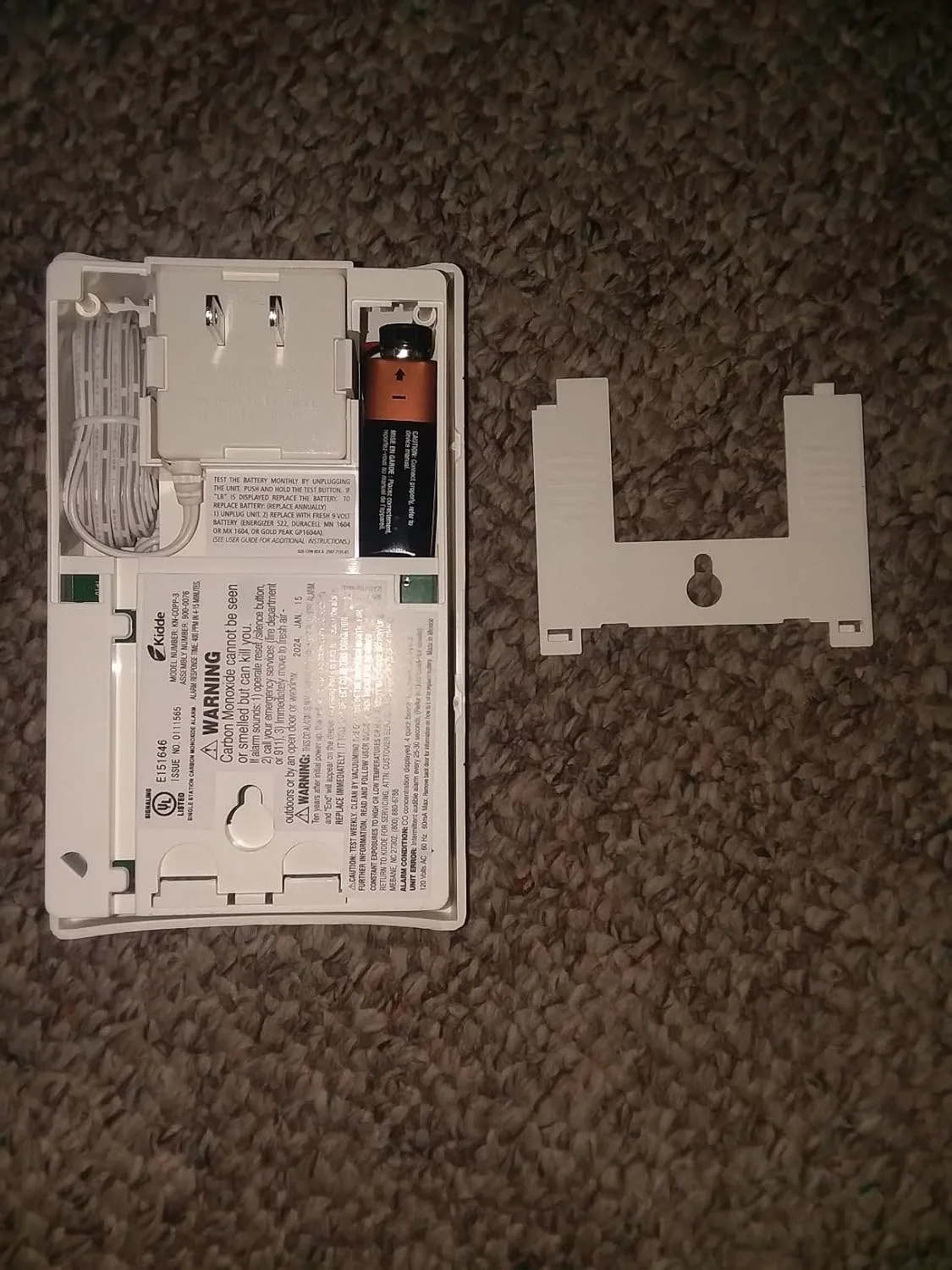 Customer photo showing CO detector mounted on wall near ceiling in bedroom