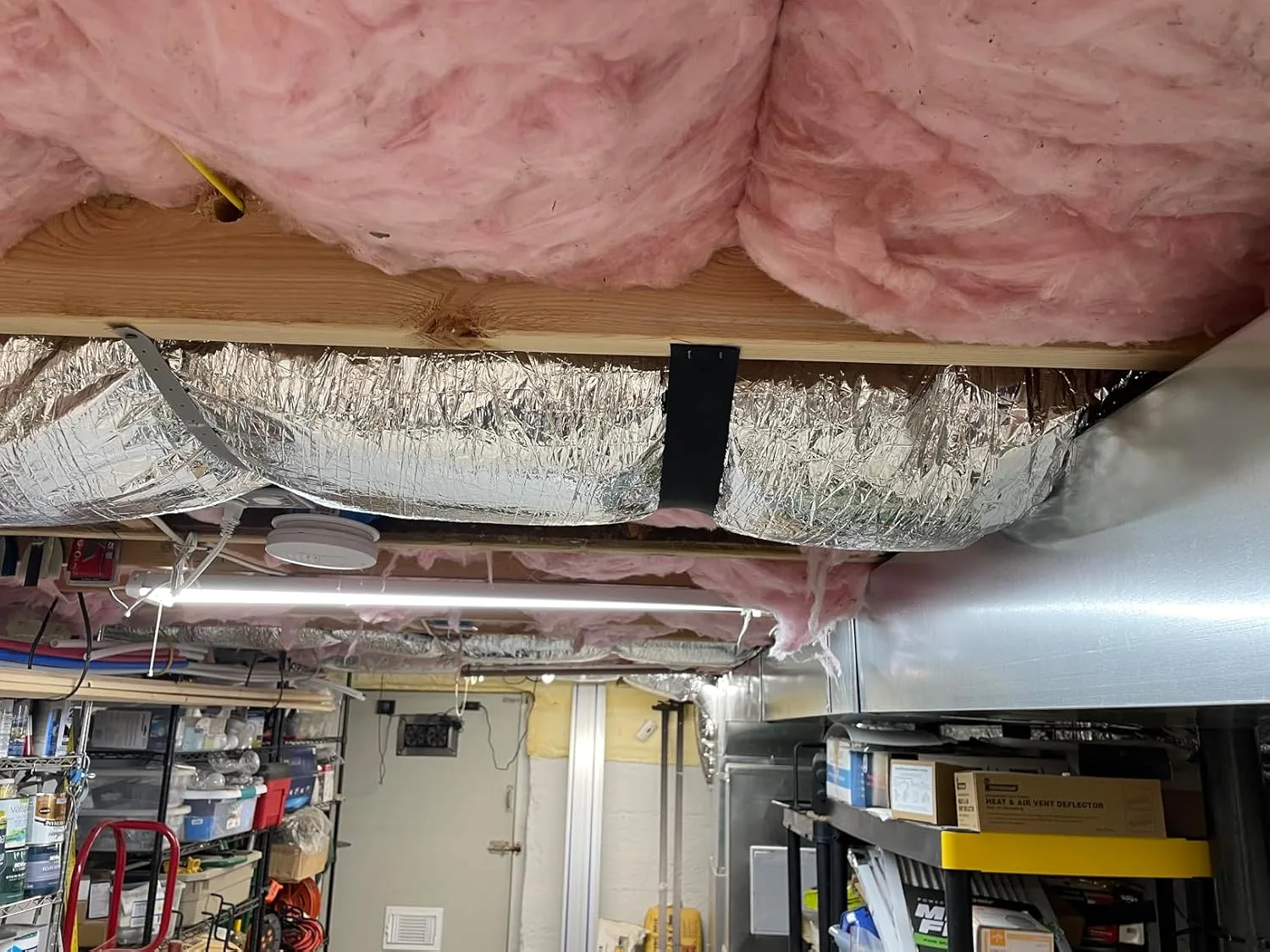 Customer photo of kinked flex duct showing collapsed airflow restriction